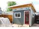 Modern shed with a red door, wood siding, and multiple windows at 3725 S Acoma St, Englewood, CO 80110