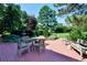Beautiful brick patio features a dining table with seating surrounded by a lush backyard at 4845 S Gaylord St, Cherry Hills Village, CO 80113