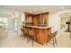 Basement bar area showcasing wood cabinetry, granite countertops, and seating for five at 4845 S Gaylord St, Cherry Hills Village, CO 80113