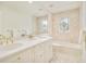 Bright bathroom vanity with marble countertops, gold hardware, and shower/tub at 4845 S Gaylord St, Cherry Hills Village, CO 80113