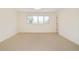 Large, bright bedroom with neutral carpet and large windows at 4845 S Gaylord St, Cherry Hills Village, CO 80113