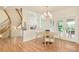 Bright dining room featuring wood floors, a modern chandelier, and french doors at 4845 S Gaylord St, Cherry Hills Village, CO 80113