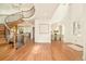 Welcoming foyer featuring a sweeping staircase, hardwood floors, and entry to the formal dining room at 4845 S Gaylord St, Cherry Hills Village, CO 80113