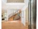 Bright foyer with a winding staircase, hardwood floors, and open access to the living area at 4845 S Gaylord St, Cherry Hills Village, CO 80113