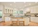 Bright kitchen with island, breakfast bar, and stainless steel appliances, perfect for culinary enthusiasts at 4845 S Gaylord St, Cherry Hills Village, CO 80113