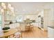 Bright kitchen featuring wood floors, granite counters, a large island with seating, and stainless steel appliances at 4845 S Gaylord St, Cherry Hills Village, CO 80113