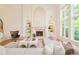 Elegant living room features fireplace, built-in shelves, large windows overlooking nature, and comfortable seating at 4845 S Gaylord St, Cherry Hills Village, CO 80113