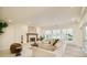 Spacious living room featuring fireplace, neutral furniture, and large windows at 4845 S Gaylord St, Cherry Hills Village, CO 80113