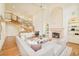 Bright living room with fireplace, chandelier, winding staircase, and large windows at 4845 S Gaylord St, Cherry Hills Village, CO 80113
