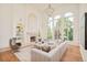 Comfortable living room with fireplace, built-in shelves, and large windows overlooking the greenery at 4845 S Gaylord St, Cherry Hills Village, CO 80113