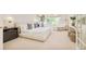 Bright main bedroom boasts neutral carpet, sliding door to private balcony, and ample natural light at 4845 S Gaylord St, Cherry Hills Village, CO 80113