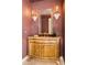 Stylish powder room featuring a decorative mirror, sconces, and a vanity with marble countertop at 4845 S Gaylord St, Cherry Hills Village, CO 80113