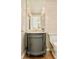 Elegant powder room featuring a decorative mirror, sconces, and a gray vanity with marble countertop at 4845 S Gaylord St, Cherry Hills Village, CO 80113