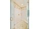 This shower area features a glass door, tile surround, and built-in bench at 4845 S Gaylord St, Cherry Hills Village, CO 80113