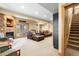 Finished basement featuring a fireplace, comfortable seating, and access to the staircase at 7465 Kelty Trl, Franktown, CO 80116