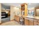 Bathroom featuring dual sinks, wooden cabinetry, decorative mirrors and a fireplace view at 7465 Kelty Trl, Franktown, CO 80116