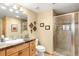 Bathroom with a glass-enclosed shower, tiled walls, and a wood vanity with plenty of storage at 7465 Kelty Trl, Franktown, CO 80116