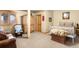 Comfortable bedroom featuring neutral walls and carpeting plus a plush bed with decorative pillows at 7465 Kelty Trl, Franktown, CO 80116