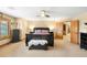 Bedroom with plush carpet, a decorative bench and dark wood furnishings at 7465 Kelty Trl, Franktown, CO 80116
