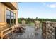Outdoor deck showcasing wooden furniture and scenic views of lush greenery at 7465 Kelty Trl, Franktown, CO 80116