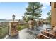 Outdoor deck showcasing stone pillars, wooden furniture and panoramic views at 7465 Kelty Trl, Franktown, CO 80116