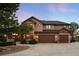 Charming home featuring stone accents, a spacious three-car garage, and manicured landscaping at 7465 Kelty Trl, Franktown, CO 80116