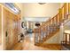 Welcoming foyer with hardwood floors, a staircase, and a view into the formal living area at 7465 Kelty Trl, Franktown, CO 80116