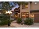 Inviting front entrance with stone accents, a covered porch, and a landscaped walkway at 7465 Kelty Trl, Franktown, CO 80116