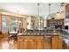 Bright kitchen view of breakfast nook and stone fireplace, with granite countertops and wood cabinetry at 7465 Kelty Trl, Franktown, CO 80116