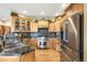 Gourmet kitchen featuring stainless steel appliances, custom cabinets, and stone countertops and backsplash at 7465 Kelty Trl, Franktown, CO 80116