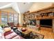 Living room featuring a stone fireplace, hardwood floors, and a large window with a view at 7465 Kelty Trl, Franktown, CO 80116