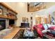 Spacious living room with stone fireplace, wooden accents, and staircase leading to the loft at 7465 Kelty Trl, Franktown, CO 80116