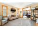 Comfortable living room featuring soft carpet, natural lighting, and an open doorway to the dining room at 7465 Kelty Trl, Franktown, CO 80116