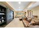 Inviting living room features a stone fireplace, built-in shelving, and comfortable leather seating at 7465 Kelty Trl, Franktown, CO 80116