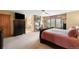 Spacious main bedroom featuring a fireplace, TV, and scenic views from the window at 7465 Kelty Trl, Franktown, CO 80116