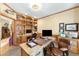 Spacious office featuring custom cabinetry and a comfortable seating area for productivity at 7465 Kelty Trl, Franktown, CO 80116