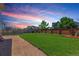 Serene backyard featuring a manicured lawn, gravel walkway, and comfortable seating area for ultimate relaxation at 1933 Griffin Dr, Brighton, CO 80601