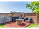 Inviting backyard with a cozy seating area around a stone fire pit, perfect for outdoor relaxation and gatherings at 1933 Griffin Dr, Brighton, CO 80601