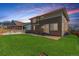 Beautiful backyard featuring a well-maintained lawn and a two-story house, ideal for outdoor activities and relaxation at 1933 Griffin Dr, Brighton, CO 80601