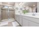 Bright bathroom with double vanity, spacious glass shower, and modern fixtures at 1933 Griffin Dr, Brighton, CO 80601