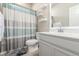 Full bathroom featuring a vanity with white cabinets, toilet, tub, and decorative shower curtain at 1933 Griffin Dr, Brighton, CO 80601