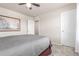 Bedroom with a ceiling fan, painting on the wall, and a white door, providing a serene space at 1933 Griffin Dr, Brighton, CO 80601