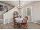 Charming dining area with round table, decorative chandelier, and natural light from the window at 1933 Griffin Dr, Brighton, CO 80601