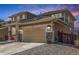 Angle of the house showing the driveway leading to the 2-car garage and the sidewalk leading to the front door at 1933 Griffin Dr, Brighton, CO 80601