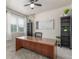 Bright home office with a spacious wooden desk and neutral decor at 1933 Griffin Dr, Brighton, CO 80601