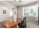 Bright home office with a spacious wooden desk and neutral decor at 1933 Griffin Dr, Brighton, CO 80601