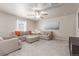 Spacious living room with neutral decor, comfortable seating, and large windows providing natural light at 1933 Griffin Dr, Brighton, CO 80601