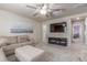 Relaxing living room showcasing neutral decor, comfortable seating, and a mounted TV for entertainment at 1933 Griffin Dr, Brighton, CO 80601