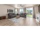 Comfortable living room with large couches, fireplace, sliding doors, and a view of the backyard at 1933 Griffin Dr, Brighton, CO 80601