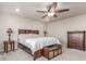 Comfortable main bedroom featuring a king-sized bed, neutral paint, and a ceiling fan at 1933 Griffin Dr, Brighton, CO 80601